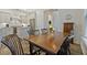 Dining area shows hardwood floors, view of kitchen with white cabinets, and a wooden table at 1098 Central Park Rd, Decatur, GA 30033
