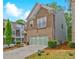 Two-story home featuring a brick and stone exterior, two car garage, and well maintained landscaping at 1098 Central Park Rd, Decatur, GA 30033