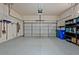 Spacious garage with epoxy flooring, overhead lighting, and ample storage shelving along the side wall at 1098 Central Park Rd, Decatur, GA 30033