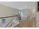 A landing at the top of the stairs has wood flooring and views of other rooms of the home at 1098 Central Park Rd, Decatur, GA 30033