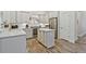Kitchen featuring an island, stainless steel appliances, white cabinets and grey countertops at 1098 Central Park Rd, Decatur, GA 30033
