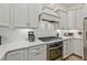 Bright kitchen features white cabinets, white subway tile, granite countertops, and stainless steel appliances at 1098 Central Park Rd, Decatur, GA 30033