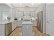 Kitchen featuring an island, stainless steel appliances, white cabinets and grey countertops at 1098 Central Park Rd, Decatur, GA 30033