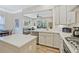 Kitchen with stainless steel appliances, white cabinets, granite countertops, and open view to living spaces at 1098 Central Park Rd, Decatur, GA 30033