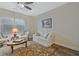 Bright sitting room with natural light, comfortable seating, and patterned area rug at 1098 Central Park Rd, Decatur, GA 30033