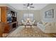 This living room includes wood floors, a ceiling fan, two chairs, and a sofa at 1098 Central Park Rd, Decatur, GA 30033