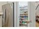 Pantry with stocked shelves near stainless refrigerator and stairway at 1098 Central Park Rd, Decatur, GA 30033