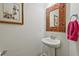 Powder room featuring pedestal sink, modern faucet and towel ring at 1098 Central Park Rd, Decatur, GA 30033