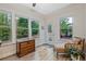 Sun room with windows boasts backyard views and a daybed at 1098 Central Park Rd, Decatur, GA 30033