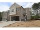 New construction home featuring a brick and siding facade with an attached two-car garage at 1974 William Glen St, Dacula, GA 30019