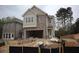 Charming two-story home with brick and beige siding and an attached two car garage in a new neighborhood at 1974 William Glen St, Dacula, GA 30019