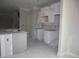 Unfinished kitchen with white cabinets and a kitchen island featuring a stainless steel sink at 1974 William Glen St, Dacula, GA 30019