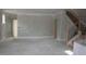 A view of the unfinished living room space featuring a stairway and an doorway at 1974 William Glen St, Dacula, GA 30019