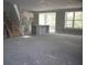 Unfinished living room featuring a kitchen island, stairs, and a wall of windows at 1974 William Glen St, Dacula, GA 30019