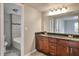 Modern bathroom features a double sink vanity, framed mirror, updated lighting, and tiled shower/tub at 2463 Corner Shoals Dr, Decatur, GA 30034