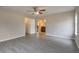 Spacious bedroom featuring grey wood flooring, neutral walls, ceiling fan, and ensuite bathroom access at 2463 Corner Shoals Dr, Decatur, GA 30034