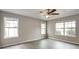 Bright Primary bedroom with large windows, neutral walls, fan, and ample natural light at 2463 Corner Shoals Dr, Decatur, GA 30034