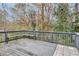 Exterior deck with bench seating, overlooking wooded backyard at 2463 Corner Shoals Dr, Decatur, GA 30034