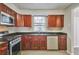 Modern kitchen featuring dark cabinets, stainless steel appliances, and durable granite countertops at 2463 Corner Shoals Dr, Decatur, GA 30034