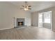 Bright living room featuring a fireplace, a large window bay and stylish gray flooring at 2463 Corner Shoals Dr, Decatur, GA 30034