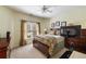 Serene bedroom with natural light, ceiling fan, dresser and a bed with plush pillows and blankets at 4249 Millside Walk, Smyrna, GA 30080