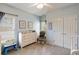 Bright bedroom featuring a ceiling fan, a changing table and soft, neutral carpet at 4249 Millside Walk, Smyrna, GA 30080