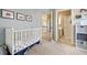 Carpeted Bedroom with a crib and pictures hanging on the light blue walls at 4249 Millside Walk, Smyrna, GA 30080