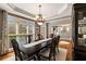Dining room featuring large windows, a dark wood table, and an elegant china cabinet at 4249 Millside Walk, Smyrna, GA 30080
