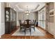 Elegant dining room featuring a large wooden table, chandelier, and a decorative china cabinet at 4249 Millside Walk, Smyrna, GA 30080
