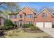 Charming two-story brick home with a well-manicured lawn and attached two car garage at 4249 Millside Walk, Smyrna, GA 30080