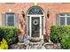 Charming front door with sidelights and transom window with a brick surround at 4249 Millside Walk, Smyrna, GA 30080