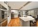 Spacious open kitchen with an island, white cabinets, stainless appliances, and easy access to other living areas at 4249 Millside Walk, Smyrna, GA 30080
