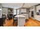Well-lit open kitchen featuring a center island, stone fireplace, and a seamless view into a seating area at 4249 Millside Walk, Smyrna, GA 30080