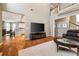 Bright living room featuring hardwood floors and an open layout into the adjacent white kitchen at 4249 Millside Walk, Smyrna, GA 30080