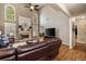 Inviting living room featuring hardwood floors and a cozy fireplace beneath soaring, window-lined vaulted ceilings at 4249 Millside Walk, Smyrna, GA 30080