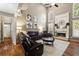 Comfortable living room featuring a fireplace, hardwood floors, and a plush leather sectional for relaxing at 4249 Millside Walk, Smyrna, GA 30080
