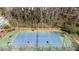 Aerial view of a well-maintained community tennis court surrounded by mature trees at 4249 Millside Walk, Smyrna, GA 30080
