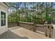 Wood back deck overlooking a private, wooded backyard, perfect for outdoor entertaining and relaxation at 4306 Thorngate Ln, Acworth, GA 30101