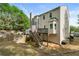 View of the home's backyard featuring a wood fence, lawn, deck, and stairs leading up to the house at 4306 Thorngate Ln, Acworth, GA 30101