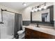 Bathroom with granite vanity, neutral walls, framed mirror, shower, and modern lighting at 4306 Thorngate Ln, Acworth, GA 30101