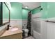 Bright bathroom with decorative mirror, shower with sleek hardware and green accent walls at 4306 Thorngate Ln, Acworth, GA 30101
