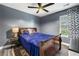 Cozy bedroom features a comfortable bed, window with decorative curtains and modern ceiling fan at 4306 Thorngate Ln, Acworth, GA 30101