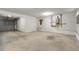 Unfinished garage with water heater, electrical panel, garage door and cement floor at 4306 Thorngate Ln, Acworth, GA 30101