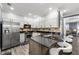 Modern kitchen with stainless steel appliances, granite countertops, and custom cabinetry and backsplash at 4306 Thorngate Ln, Acworth, GA 30101