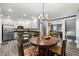 Open kitchen featuring stainless steel appliances, a breakfast bar, and a view to the dining area at 4306 Thorngate Ln, Acworth, GA 30101
