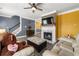 Inviting living room with a fireplace, TV, and cozy seating area; perfect for relaxing and entertaining guests at 4306 Thorngate Ln, Acworth, GA 30101