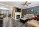 Cozy living room featuring a fireplace, TV, and an open view into the kitchen and dining area at 4306 Thorngate Ln, Acworth, GA 30101