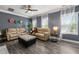 Bright living room with hardwood floors, modern decor, and plenty of natural light streaming through the windows at 4306 Thorngate Ln, Acworth, GA 30101