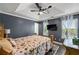 Spacious main bedroom boasts a trey ceiling, natural light, and TV for comfortable living at 4306 Thorngate Ln, Acworth, GA 30101