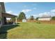 Large, lush backyard with a covered patio and a storage shed, offering ample outdoor space at 7514 Absinth Dr Pass, Atlanta, GA 30349